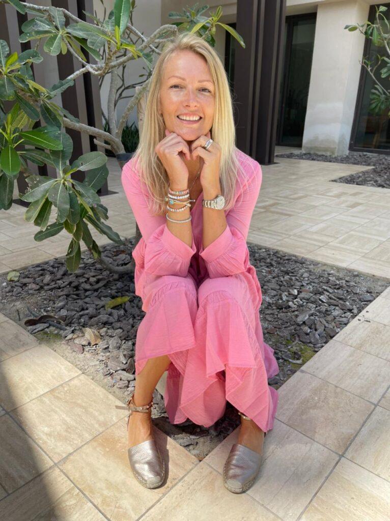 Lucy Gibson Sand Dollar Dubai Women's Fashion Boutique Founder Wearing Pink Summer Dress 